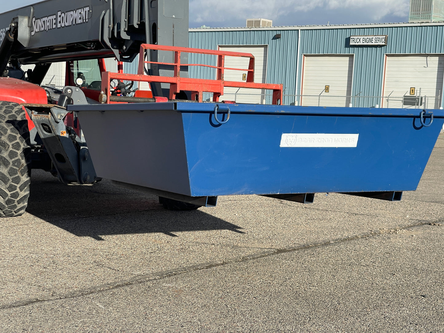 3 cubic yard concrete washout container picked up by a forklift